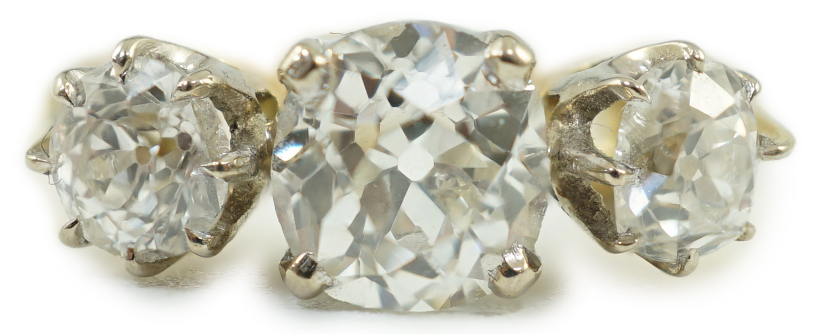 A modern 18ct gold and three stone diamond set ring